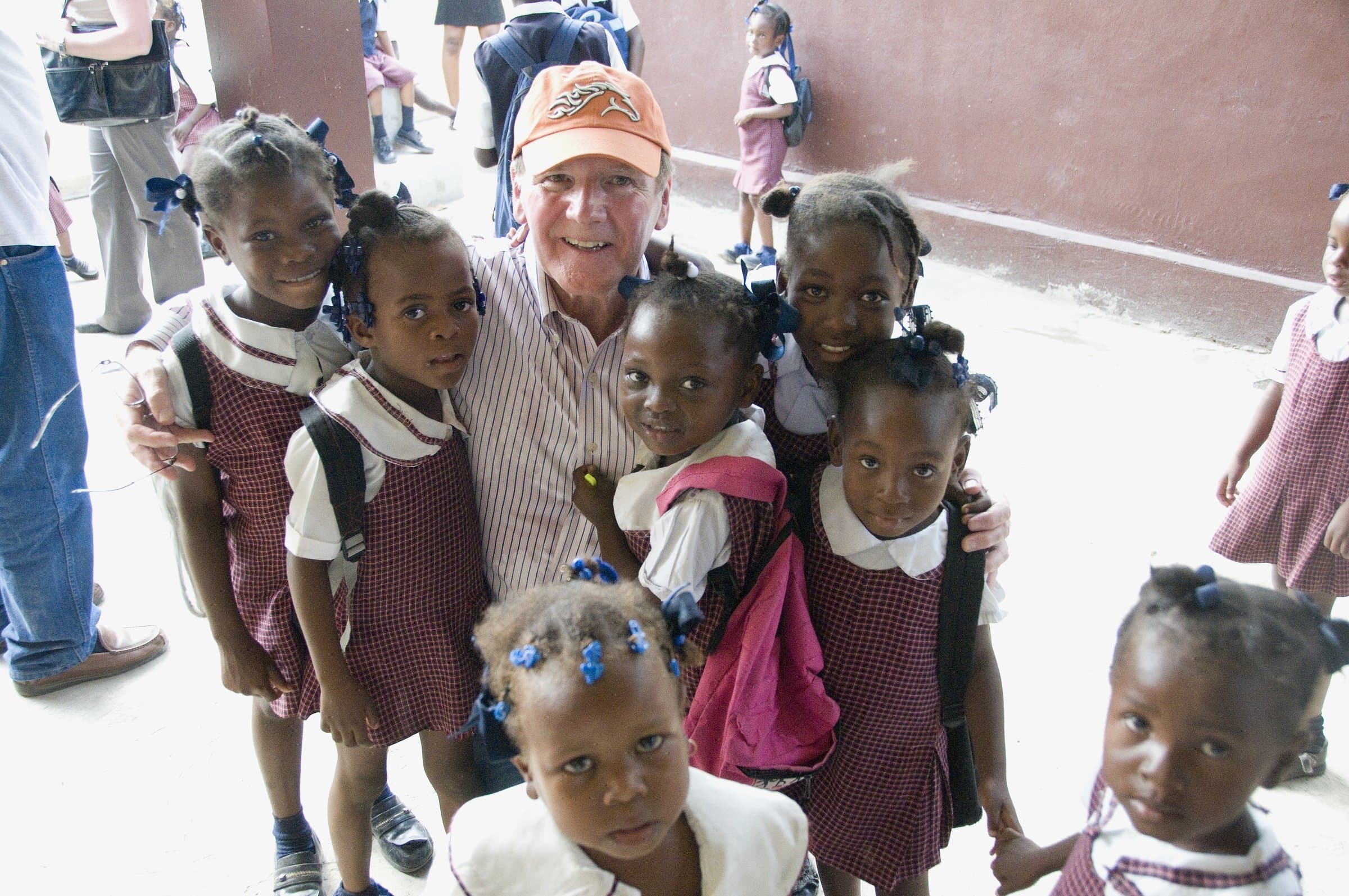 Students and a foundation supporter inside a classroom in Haiti