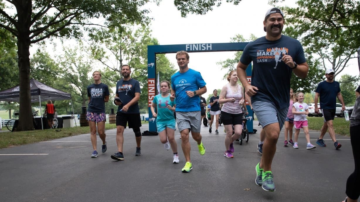 Participants crossing the finish line at the Make a Difference Dash
